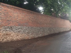 Re-built boundary wall on manor house 